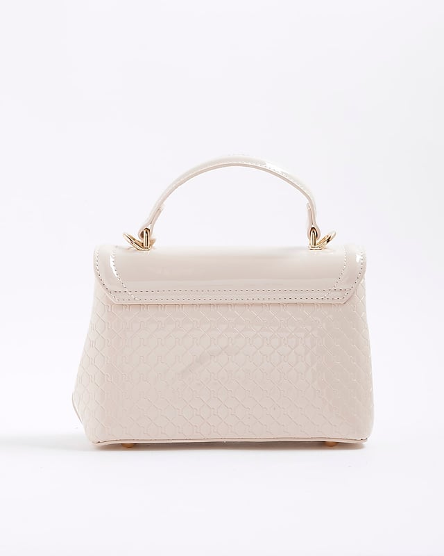 River Island Womens Tote Bag Cream Patent RI Flap Patent, RI monogram print, Grab handle, Detachable cross body strap, Charm detail, Gold branding, Interior zipped compartment, Front flap closure, Strap length: 60cm, H: 16cm x W: 24cm x D: 10cm
