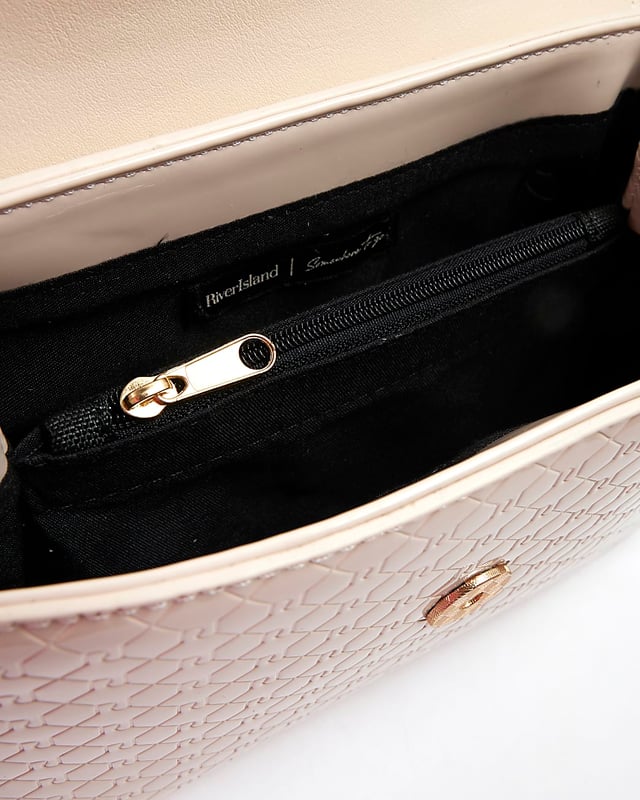 River Island Womens Tote Bag Cream Patent RI Flap Patent, RI monogram print, Grab handle, Detachable cross body strap, Charm detail, Gold branding, Interior zipped compartment, Front flap closure, Strap length: 60cm, H: 16cm x W: 24cm x D: 10cm