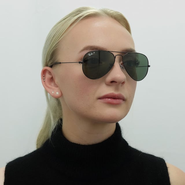 Ray-Ban Sunglasses Aviator 3025 Black Green Polarized 002/58 were originally designed in 1936 for US military pilots and have since become one of the most iconic sunglasses models in the world. The timeless design is characterised by the thin metal wire frame, large teardrop shaped lenses and fine metal temples that feature silicone tips and nose pads for a customised and comfortable fit. This classic model is available in various sizes and an array of colourways.