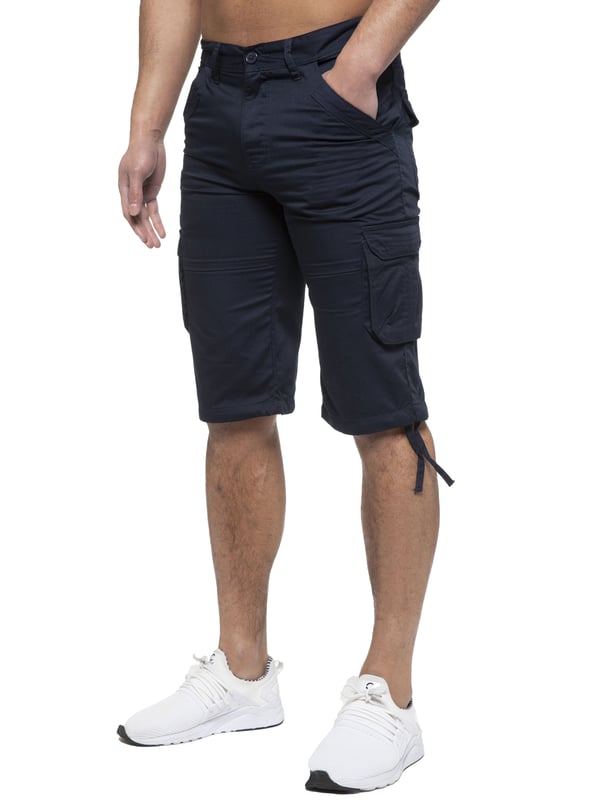 Enzo Mens Cargo Combat Jeans. 7 Pocket Design Including Single Coin Pocket. 2 Front Slash Pockets with Extra Fabric Stitching Detail. 2 Side Cargo Pockets, 2 Back Bellow Pockets with Velcro Fastening Flap. Extra Stitching Details to all Pockets. Adjustable Drawstring to the Hems. Zip Fly Fastening. Premium Quality Fabric Ideal for Casual and Heavy Duty Work Wear.