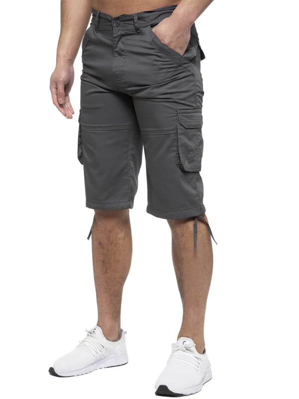 Enzo Mens Cargo Combat Jeans. 7 Pocket Design Including Single Coin Pocket. 2 Front Slash Pockets with Extra Fabric Stitching Detail. 2 Side Cargo Pockets, 2 Back Bellow Pockets with Velcro Fastening Flap. Extra Stitching Details to all Pockets. Adjustable Drawstring to the Hems. Zip Fly Fastening. Premium Quality Fabric Ideal for Casual and Heavy Duty Work Wear.