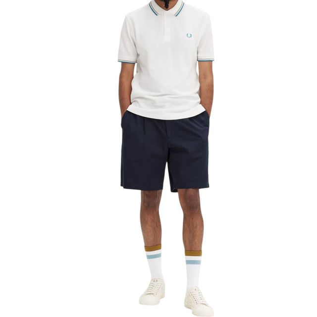 The Twin Tipped Fred Perry Polo Shirt by Fred Perry is a short sleeved polo shirt that has been made from Fred Perry's classic cotton piqué, in a contemporary adaptation of Fred's famous streamlined fit. Available in a diverse range of colourways - each with their own unique story. Featuring the signature Fred Perry wreath logo to the chest and twin tipping to the collar and cuffs.