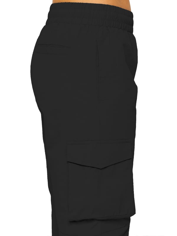Stay effortlessly stylish in the Enzo Women's Parachute Cargo Pants. Made from lightweight crushed poly fabric, they feature a relaxed fit, wide-leg cut, and an elasticated waistband with adjustable drawstring for all-day comfort. With multiple pockets—including cargo styles with velcro fastening—and adjustable drawcord hems, these utility-inspired trousers blend function with streetwear flair. Ideal for casual, off-duty looks.
