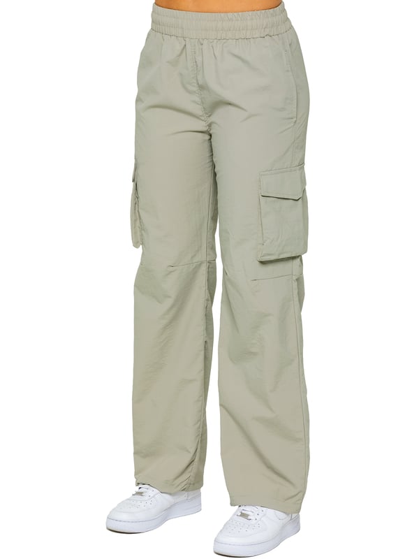 Stay effortlessly stylish in the Enzo Women's Parachute Cargo Pants. Made from lightweight crushed poly fabric, they feature a relaxed fit, wide-leg cut, and an elasticated waistband with adjustable drawstring for all-day comfort. With multiple pockets—including cargo styles with velcro fastening—and adjustable drawcord hems, these utility-inspired trousers blend function with streetwear flair. Ideal for casual, off-duty looks.