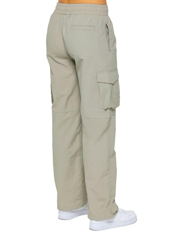 Stay effortlessly stylish in the Enzo Women's Parachute Cargo Pants. Made from lightweight crushed poly fabric, they feature a relaxed fit, wide-leg cut, and an elasticated waistband with adjustable drawstring for all-day comfort. With multiple pockets—including cargo styles with velcro fastening—and adjustable drawcord hems, these utility-inspired trousers blend function with streetwear flair. Ideal for casual, off-duty looks.