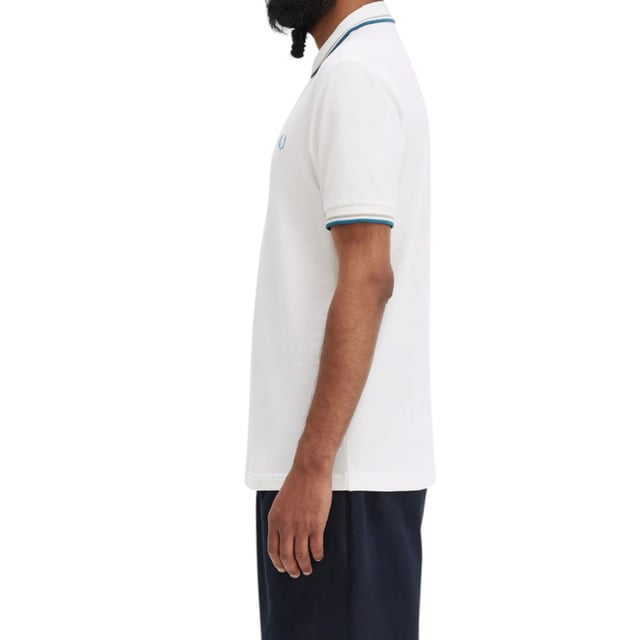 The Twin Tipped Fred Perry Polo Shirt by Fred Perry is a short sleeved polo shirt that has been made from Fred Perry's classic cotton piqué, in a contemporary adaptation of Fred's famous streamlined fit. Available in a diverse range of colourways - each with their own unique story. Featuring the signature Fred Perry wreath logo to the chest and twin tipping to the collar and cuffs.