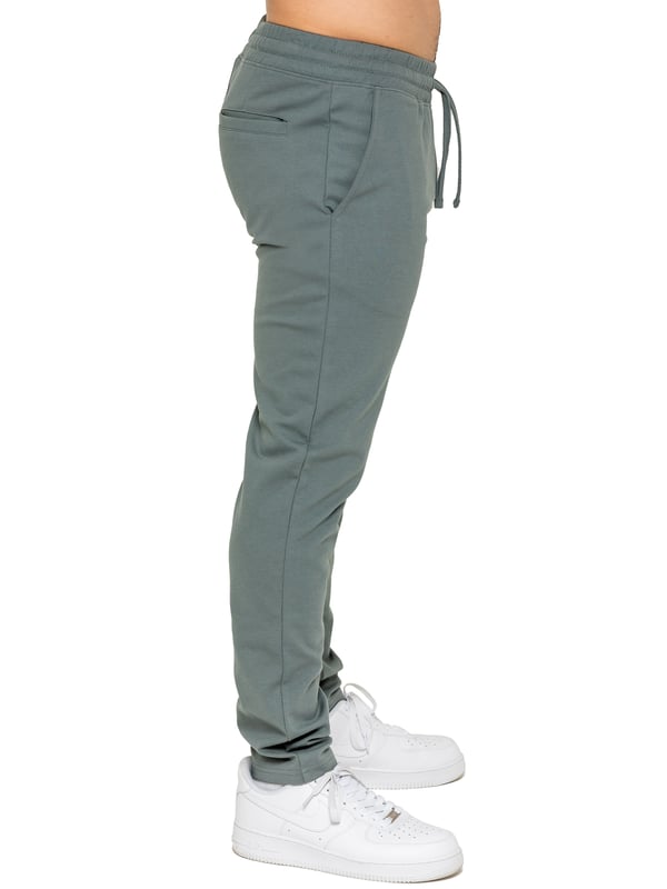 Upgrade your everyday style with the Enzo Smart Stretch Joggers, designed for both comfort and versatility. Featuring an elasticated waistband with an adjustable drawstring, these joggers ensure a secure and personalized fit. The straight-leg design offers a sleek, modern look, while the premium stretch fabric provides ultimate flexibility and all-day comfort. Functional yet stylish, they come with two side entry pockets and two back welt pockets. These joggers are the perfect blend of smart tailoring and relaxed wearability.