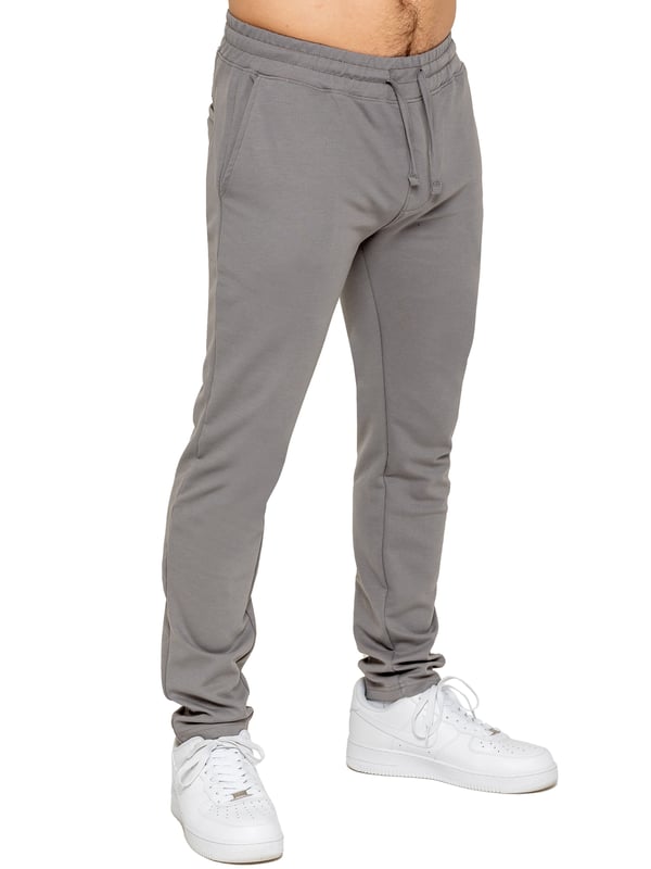 Upgrade your everyday style with the Enzo Smart Stretch Joggers, designed for both comfort and versatility. Featuring an elasticated waistband with an adjustable drawstring, these joggers ensure a secure and personalized fit. The straight-leg design offers a sleek, modern look, while the premium stretch fabric provides ultimate flexibility and all-day comfort. Functional yet stylish, they come with two side entry pockets and two back welt pockets. These joggers are the perfect blend of smart tailoring and relaxed wearability.