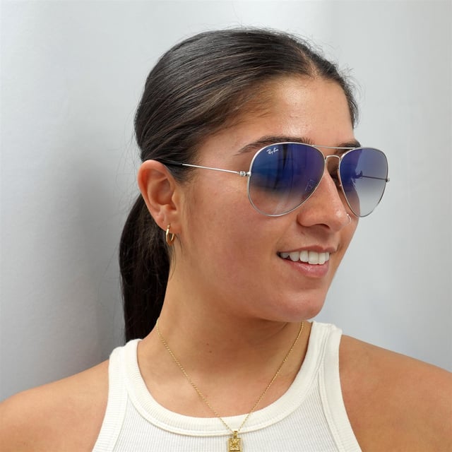 Ray-Ban Aviator 3025 Silver Gradient Blue Light Blue 003 / 3F 62mm Sonnenbrille wurde ursprünglich 1936 für amerikanische Militärpiloten entworfen und ist seitdem zu einem der kultigsten Sonnenbrillenmodelle der Welt geworden. Das zeitlose Design zeichnet sich durch den dünnen Drahtrahmen, die großen tropfenförmigen Linsen und die dünnen Metalltempel aus, die Silikonspitzen und Nasenpads für eine individuelle und bequeme Passform aufweisen. Dieses klassische Modell ist in verschiedenen Größen und einer Reihe von Farben erhältlich.