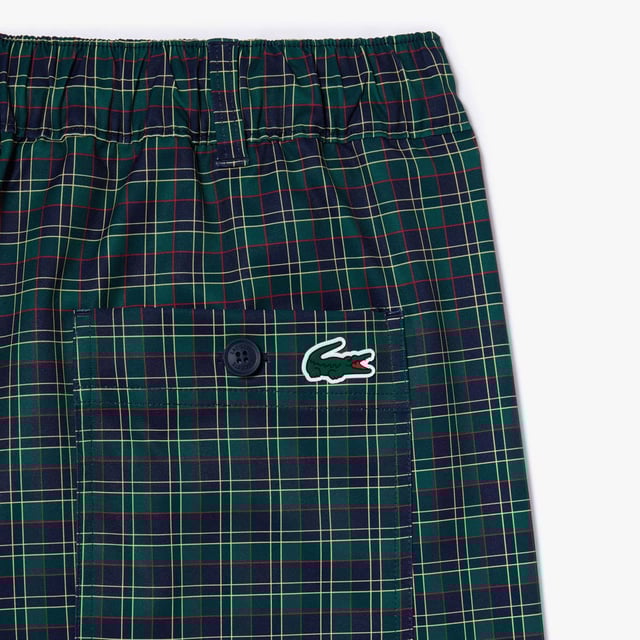 Men's Lacoste Sport Ultra-Dry checked Golf Bermuda Shorts.- Non-slip gripper tape holds top in place.- Relaxed, comfortable fit.- Ball and notebook pockets.- Elasticated waist.- Silicone crocodile. Material: 100% Polyester. Ref: FH7424IQ6.