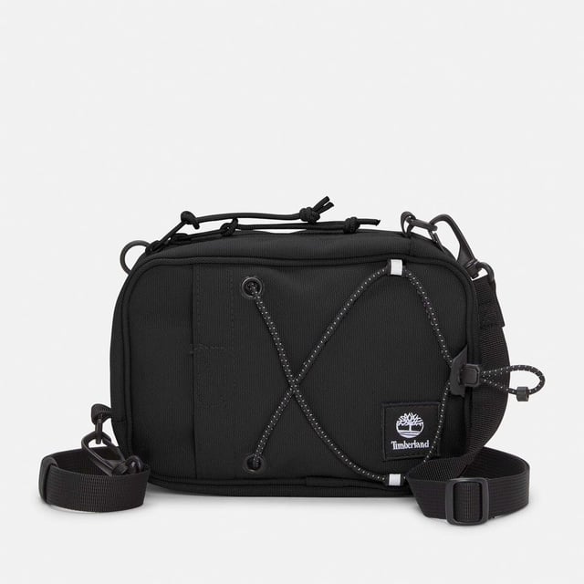 Mens Timberland Crossbody Bag in black.- Large zipper opening into main compartment.- Front panel slip pocket with bungee system and reflective details.- Adjustable shoulder strap.- Mesh back panel.- 2 ways of wearing.- Woven stacked logo badge.- Ref: A5SSY0011
