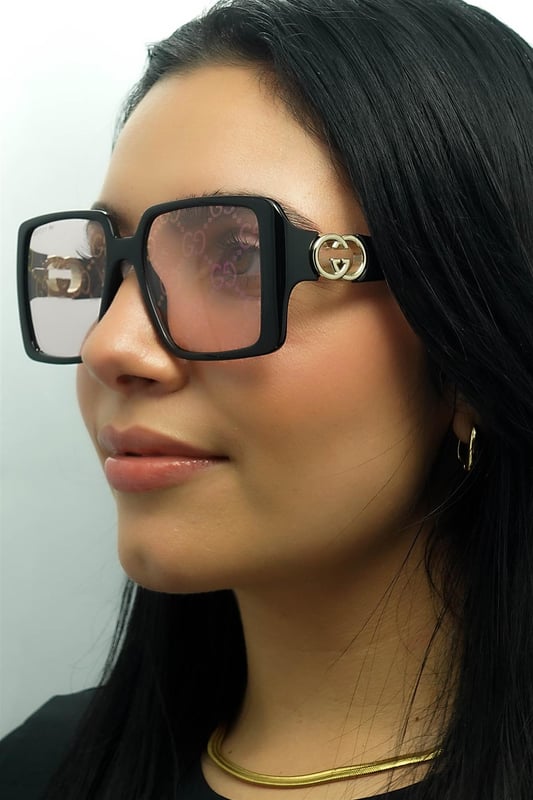 Gucci Square Womens Black with Gold Dusky Pink w Logo Mirror Photochromic GG1692S  Sunglasses feature a striking, oversized frame with a unique, softly contoured shape that enhances any look with a touch of glamour. Embellished with the iconic double-G logo on the temples, the GG1692S model proudly showcases the essence of Gucciâ€™s timeless style. The high quality lenses ensure exceptional UV protection, making them as practical as they are stylish. Available in a variety of refined colors, these sunglasses are the perfect choice for those who seek to combine bold elegance with modern fashion sensibilities.