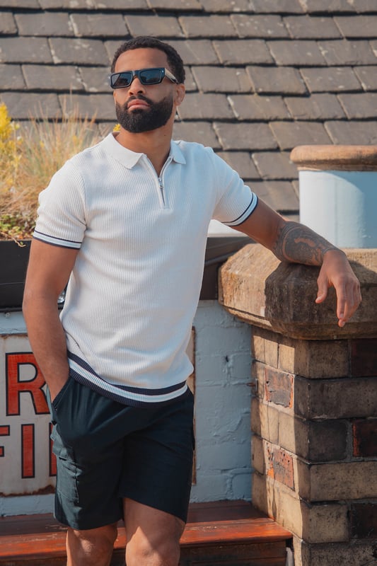 Elevate your smart-casual style with this polo from Brave Soul, designed with a sleek concealed 1/4 zip neck fastening for a clean, contemporary finish. Made from an all-over rib knit fabric, this polo offers a comfortable stretch fit with refined texture. Contrast stripe trims at the collar and cuffs add a pop of detail, to this elevated everyday essential. Model wears UK size M.