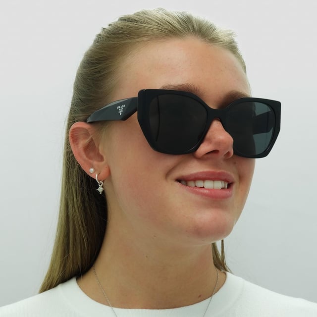 Prada Square Womens Black Dark Grey PR19ZS  Sunglasses are a modern design made of high-quality acetate material that ensures durability and comfort. The temples are adorned with the iconic Prada logo, adding a touch of sophistication. These sunglasses are perfect for any occasion, whether it's a day out in the sun or a night out on the town.