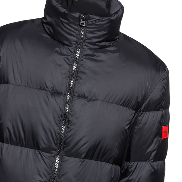 Mens HUGO Magnus Coat in back.cool leisure coat - stand collar - ribbed cuffs - zip closure and welt pockets with press button detail - HUGO logo on the sleeve- Regular fit.- Main material: 100% Polyamide (recycled)  Lining: 100% Polyester  Filling: 70% Duck down  30% Duck feather.