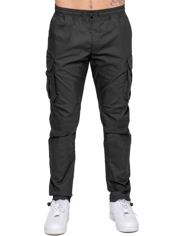 Upgrade your everyday style with the Enzo Men's Cargo Pants. Crafted from premium stretch fabric, these lightweight trousers offer a tapered leg fit for a sleek, modern look. Featuring an elasticated waistband with an adjustable toggle, they provide a customizable fit, while the adjustable toggle ankles let you tailor the look and feel. With two side slash pockets, two cargo pockets with secure Velcro fastening, and a single back welt pocket, you’ll have ample storage for essentials. Finished with an Enzo print on the cargo pocket. (649)