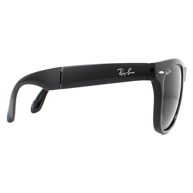 Ray-Ban Sunglasses Folding Wayfarer 4105 Black 601 50mm are a folding version of one of the most recognisable and bestselling sunglass styles worldwide and are enormously popular among celebrities, musicians and artists. The distinctive angled design and thick frame are sure to make a statement and Ray-Ban are constantly using vibrant colours and patterns to update this classic and popular style. The lightweight acetate frame is comfortable and the Ray-Ban logo is displayed on the corner of the lens in addition to the sculpted winged temples. They fold in the bridge and in the middle of the temples to give a compact finish that folds nicely into a suitable sized pouch for easy storage.