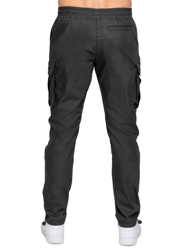 Upgrade your everyday style with the Enzo Men's Cargo Pants. Crafted from premium stretch fabric, these lightweight trousers offer a tapered leg fit for a sleek, modern look. Featuring an elasticated waistband with an adjustable toggle, they provide a customizable fit, while the adjustable toggle ankles let you tailor the look and feel. With two side slash pockets, two cargo pockets with secure Velcro fastening, and a single back welt pocket, you’ll have ample storage for essentials. Finished with an Enzo print on the cargo pocket. (649)