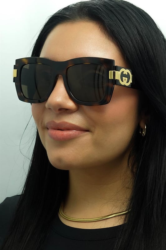 Gucci Square Womens Dark Havana with Gold Brown GG1688S  Sunglasses offer a perfect combination of modern sophistication and understated luxury. With their bold, square frame, these sunglasses make a striking fashion statement while maintaining a timeless appeal suitable for various occasions. The design is complemented by Gucciâ€™s signature double-G logo on the temples, adding a touch of iconic branding that speaks to the wearerâ€™s impeccable taste. High-quality lenses provide essential UV protection, ensuring comfort and safety without compromising on elegance.